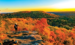 Woman sitting at the peak of Sleeping Giant