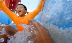 Boy sliding down waterslide at Ocean Beach in New London