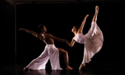 Mystic Ballet dancers in white garments on a dark stage